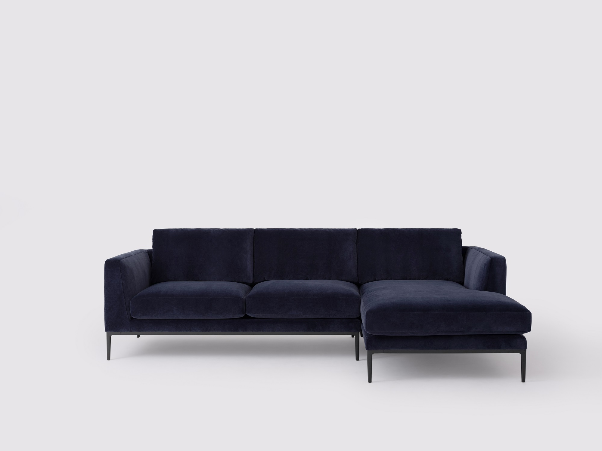 Front view of the Oma modern sectional couch in blue velvet with right hand chaise